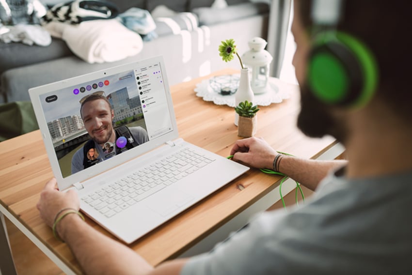 Man video chatting on his laptop with another individual