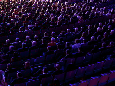 Seated audience in a theater.